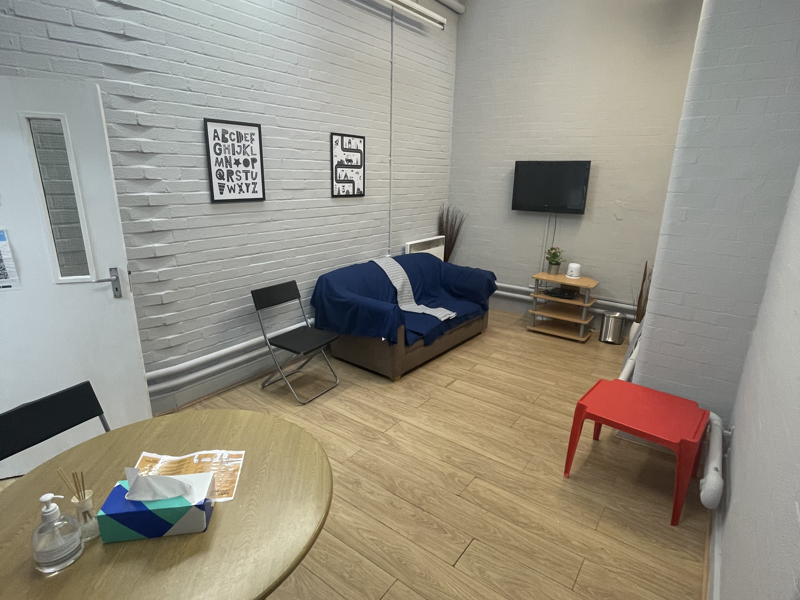 room with tv, table and sofa 