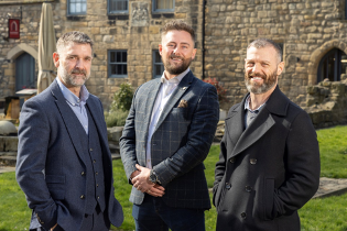 three  men dressed smartly 